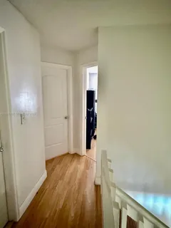 a view of a room with wooden floor and stairs