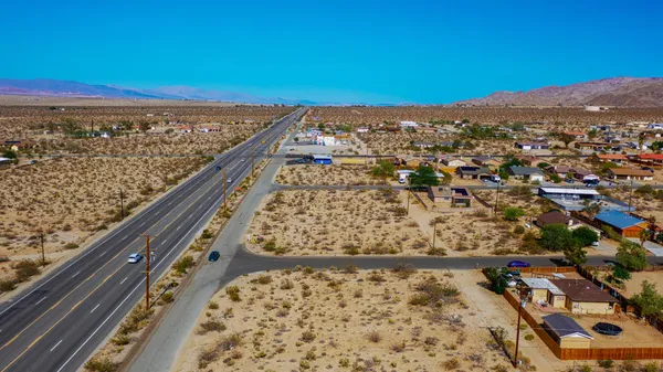 a view of a terrace with a table and chairs under an umbrella