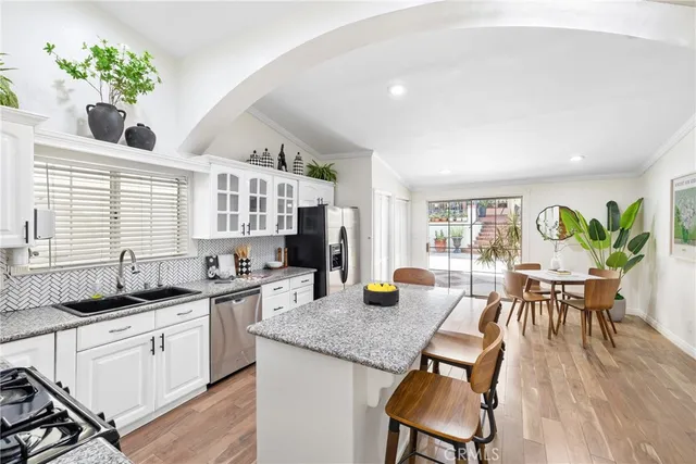 a kitchen with a table chairs stove and cabinets