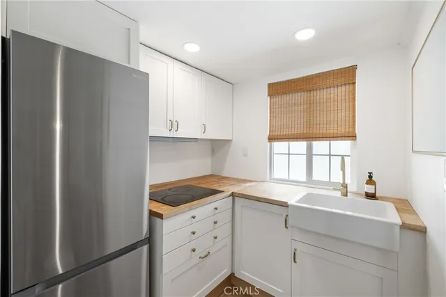 a bathroom with a sink and mirror with window