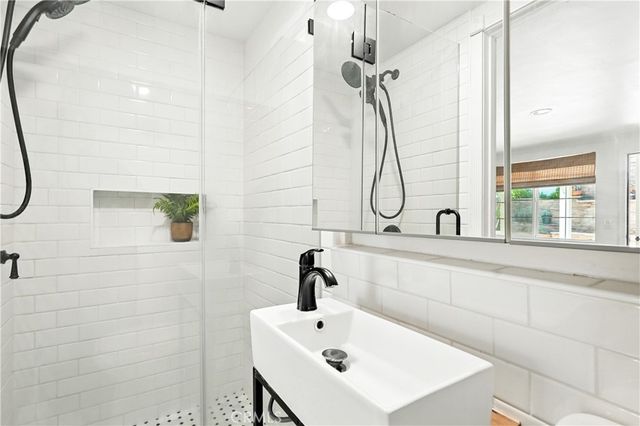 an aerial view of a house with a yard and large trees