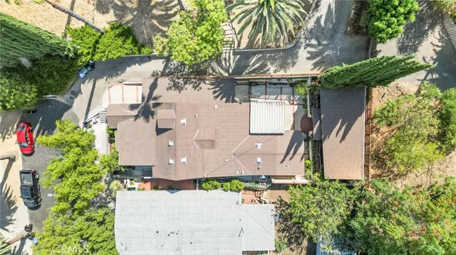 an aerial view of a house with a yard and garden