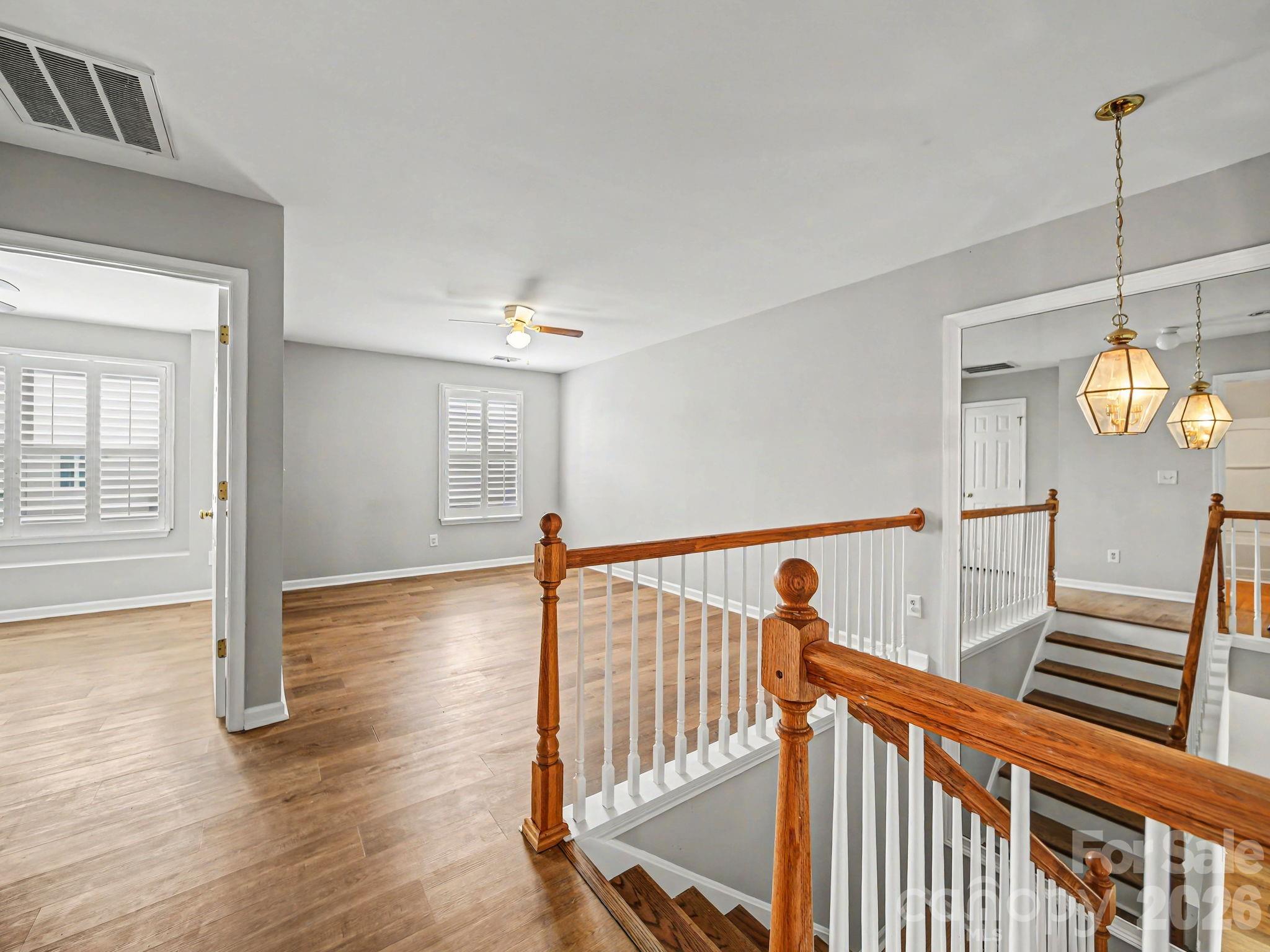 503 Delta Drive Fort Mill, SC 29715 - Photo 11 of 19 a view of a hallway with wooden floor and stairs