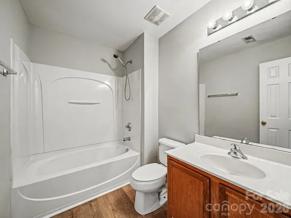 a bathroom with a sink toilet tub vanity and shower