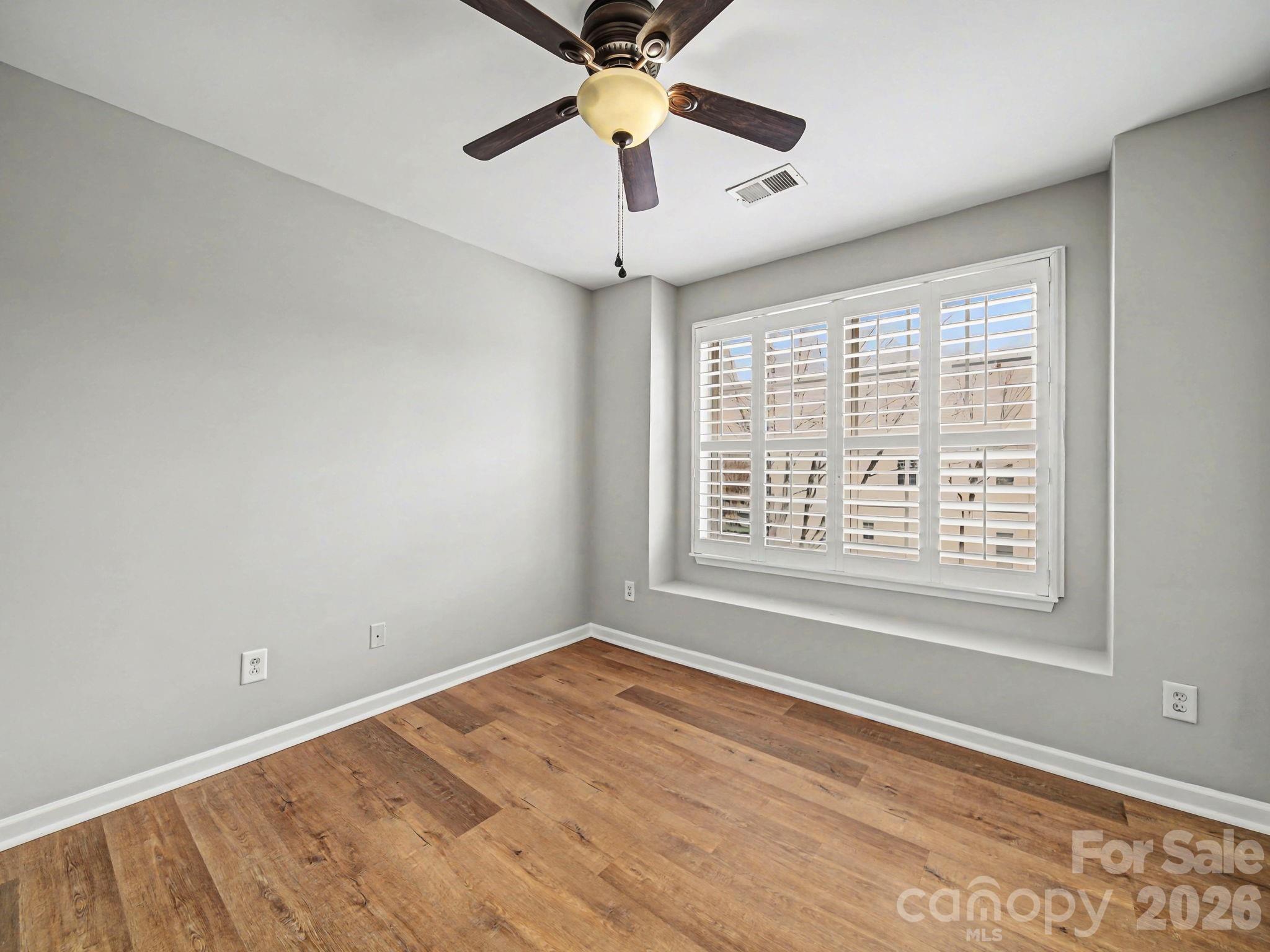 503 Delta Drive Fort Mill, SC 29715 - Photo 18 of 19 a view of an empty room with window and a chandelier fan