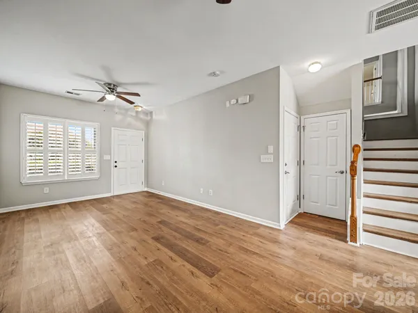 wooden floor in an empty room with a window