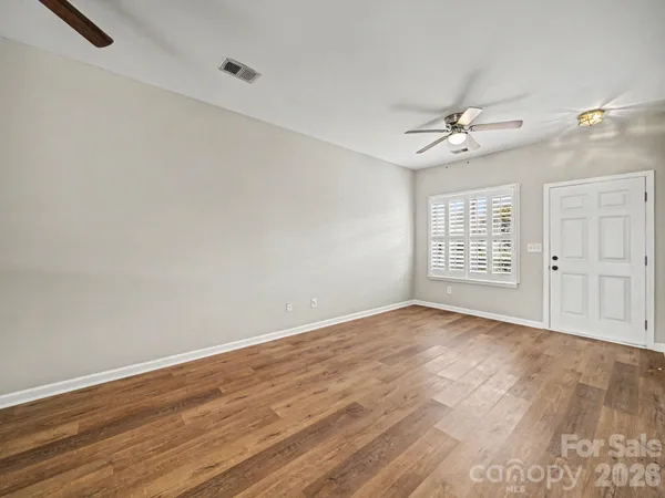 wooden floor in an empty room with a window