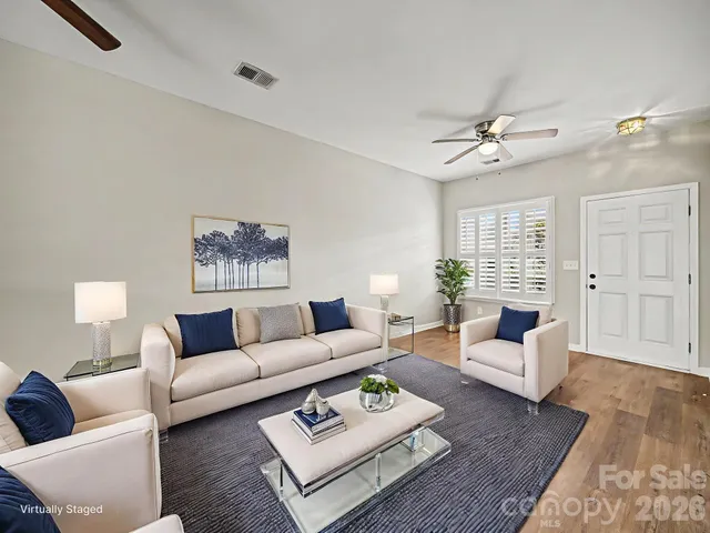 a living room with furniture rug and window