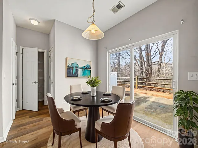 a dining room with furniture a chandelier and wooden floor