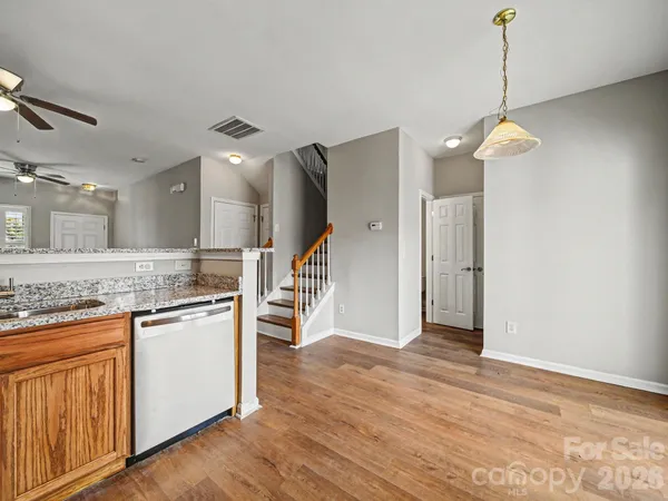 a view of a kitchen with a stove wooden floor and a kitchen