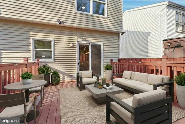 a view of a patio with couches and potted plants