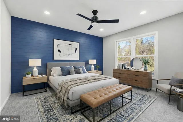 a bedroom with a bed and a large window