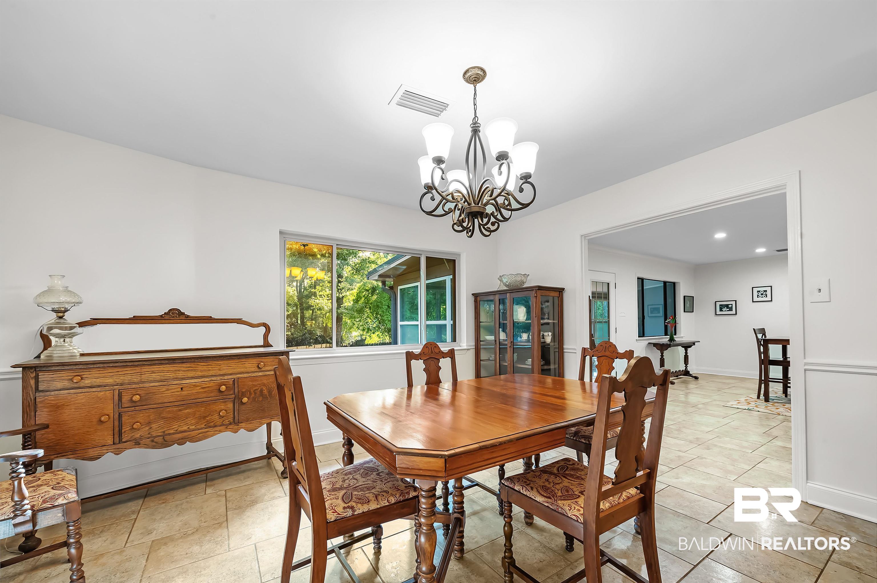104 James Circle Daphne, AL 36526 - Photo 38 of 62 Tiled dining area featuring an inviting chandelier