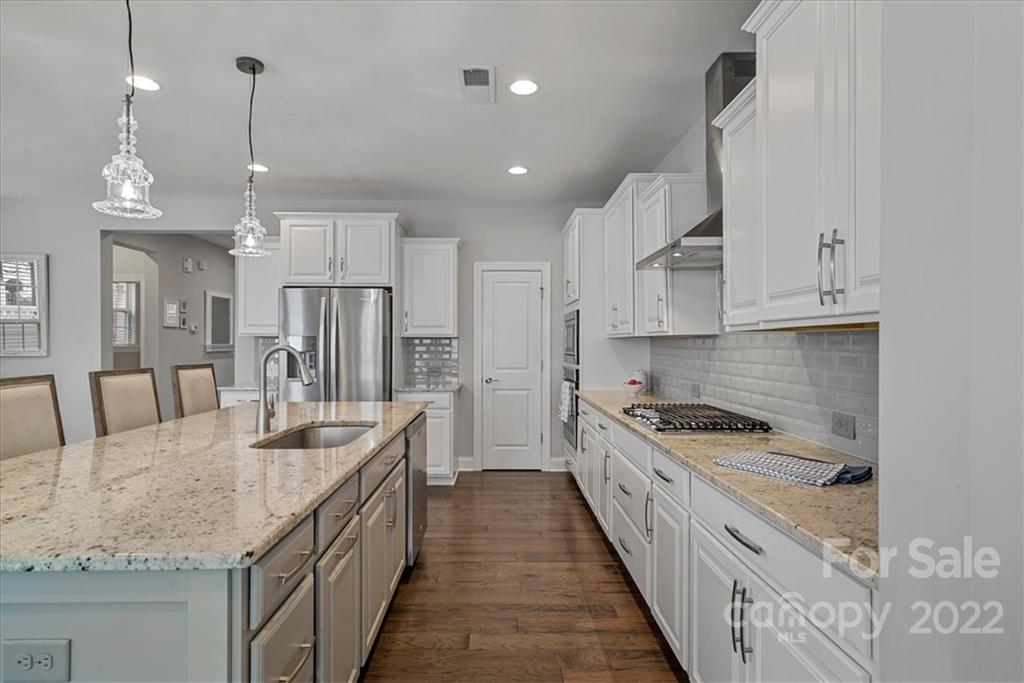 221 Helton Lane Fort Mill, SC 29708 - Photo 15 of 48 a kitchen with stainless steel appliances granite countertop a sink stove and refrigerator