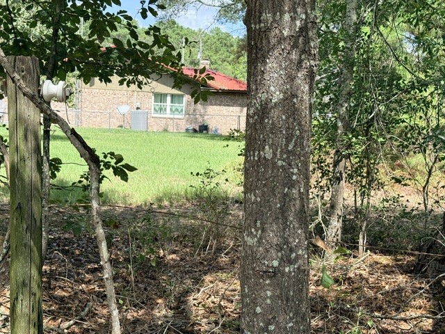 58 Roy Webb Road Huntsville, TX 77320 - Photo 24 of 31 The property goes back to the barbed wire fencing.
