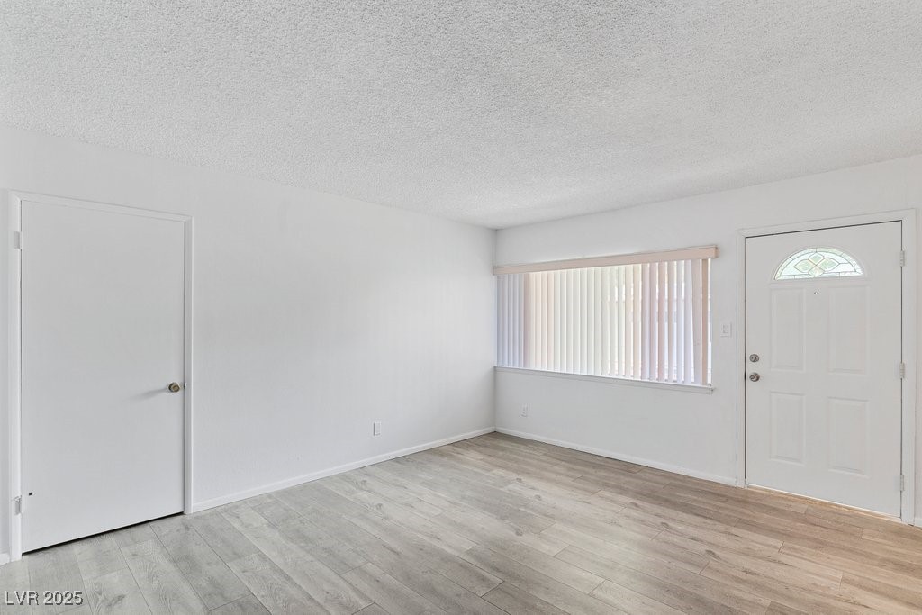 350 East Desert Inn Road, Unit H205 Las Vegas, NV 89109 - Photo 16 of 30 Entryway featuring a textured ceiling and light wood-type flooring