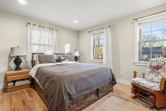 a spacious bedroom with a bed and a window