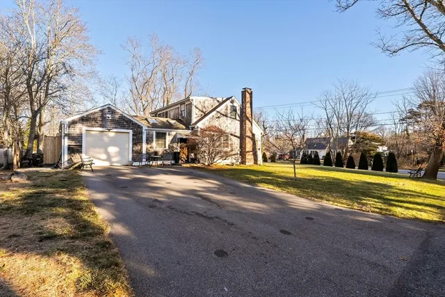 a view of a house with a yard covered with snow