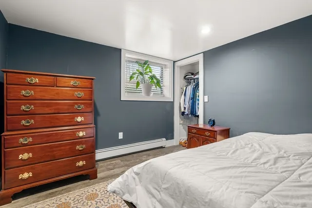 a bedroom with a bed and a dresser