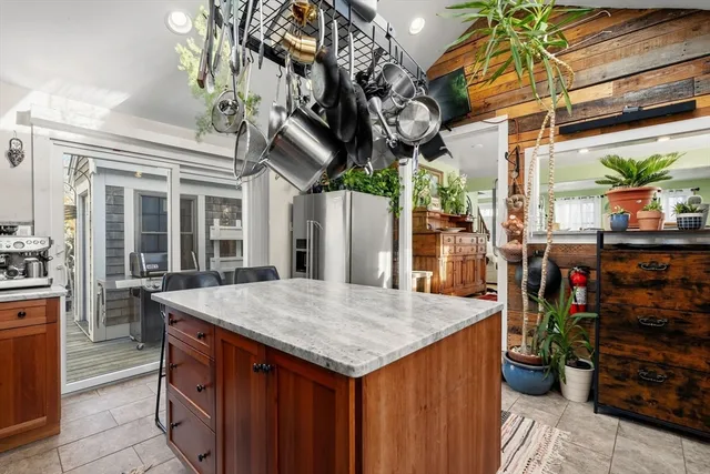 a view of a patio with table and chairs potted plants