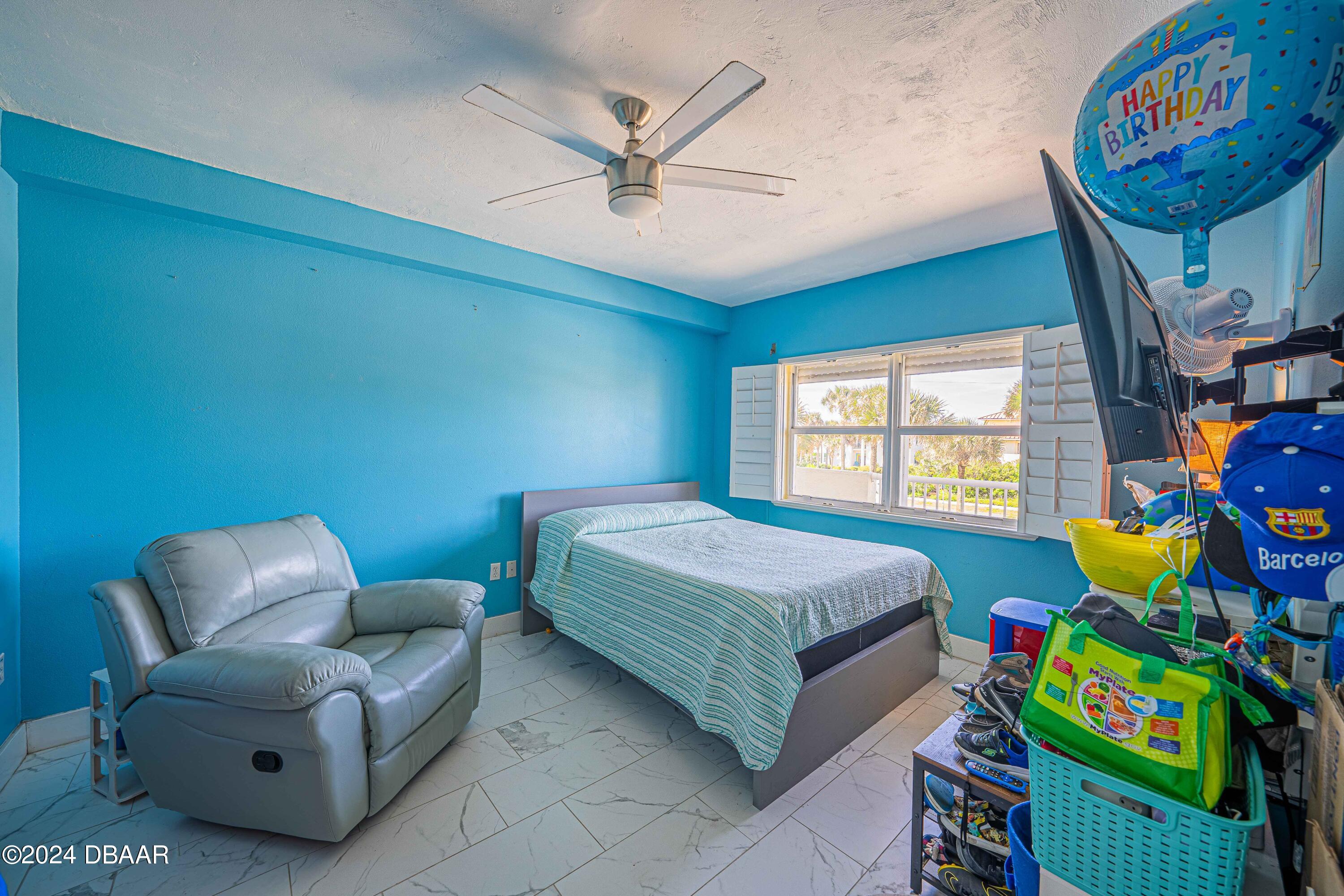 4767 South Atlantic Avenue, Unit 204 Ponce Inlet, FL 32127 - Photo 12 of 26 a bedroom with a bed and a couch