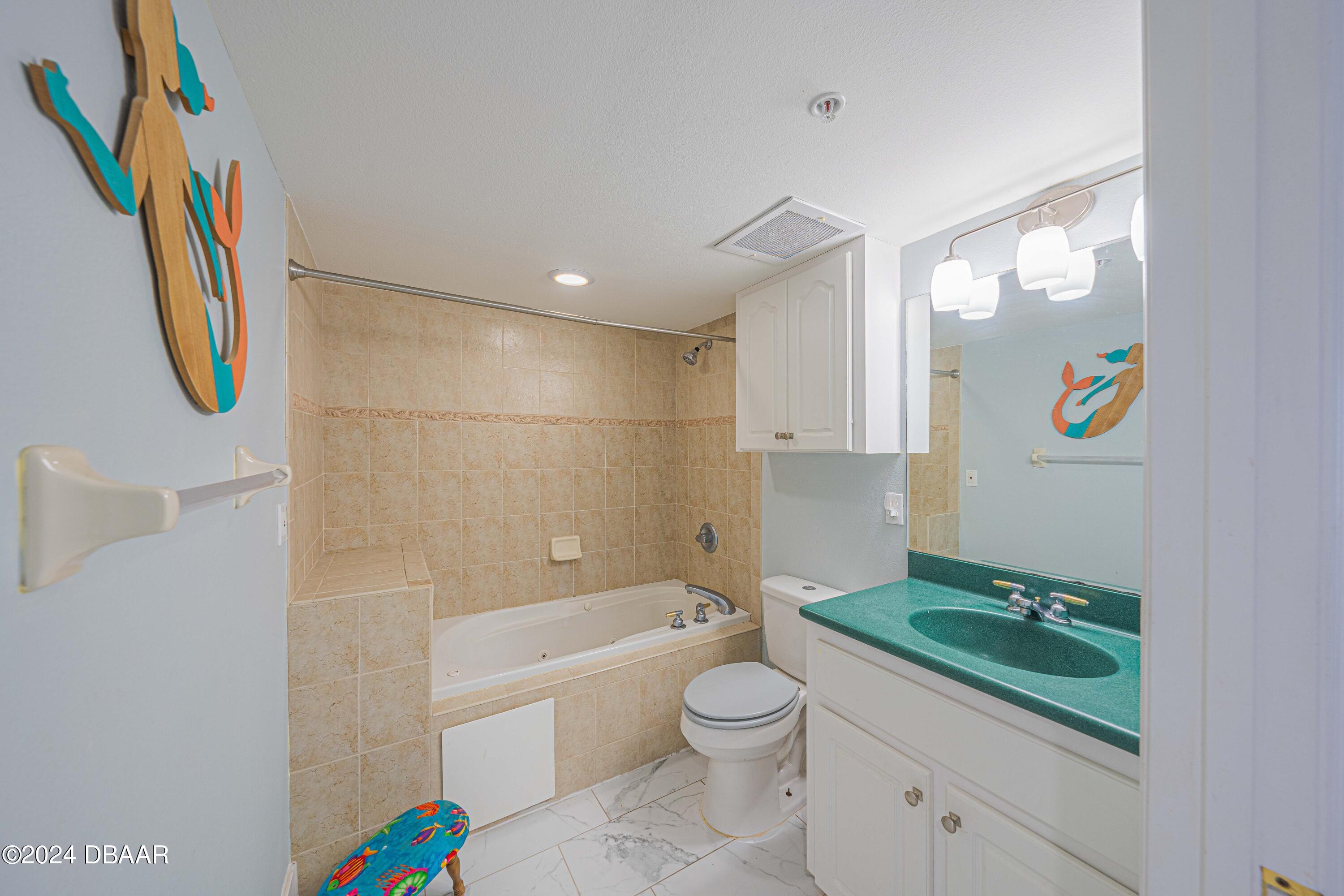 4767 South Atlantic Avenue, Unit 204 Ponce Inlet, FL 32127 - Photo 13 of 26 a bathroom with a sink a bathtub and a shower