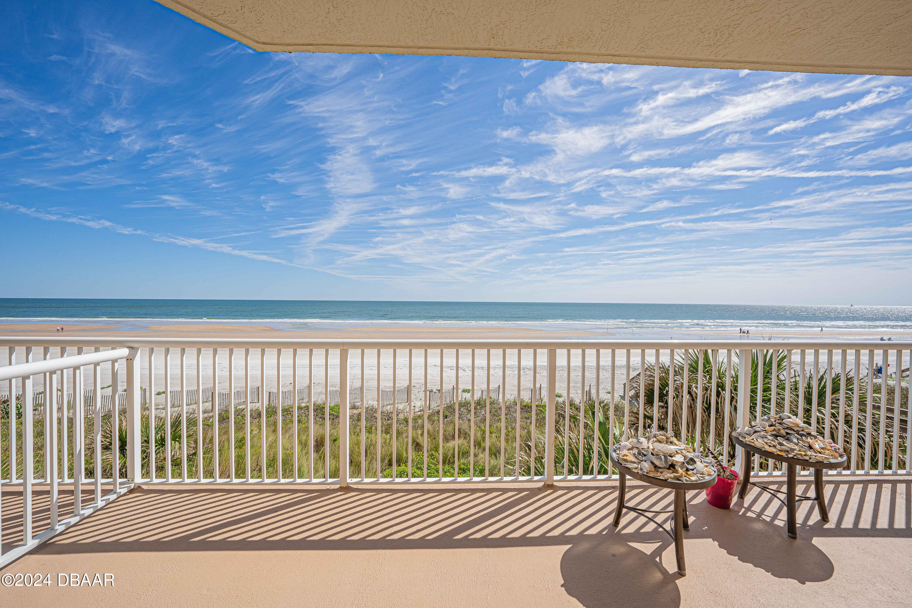 4767 South Atlantic Avenue, Unit 204 Ponce Inlet, FL 32127 - Photo 15 of 26 a balcony with table and chairs