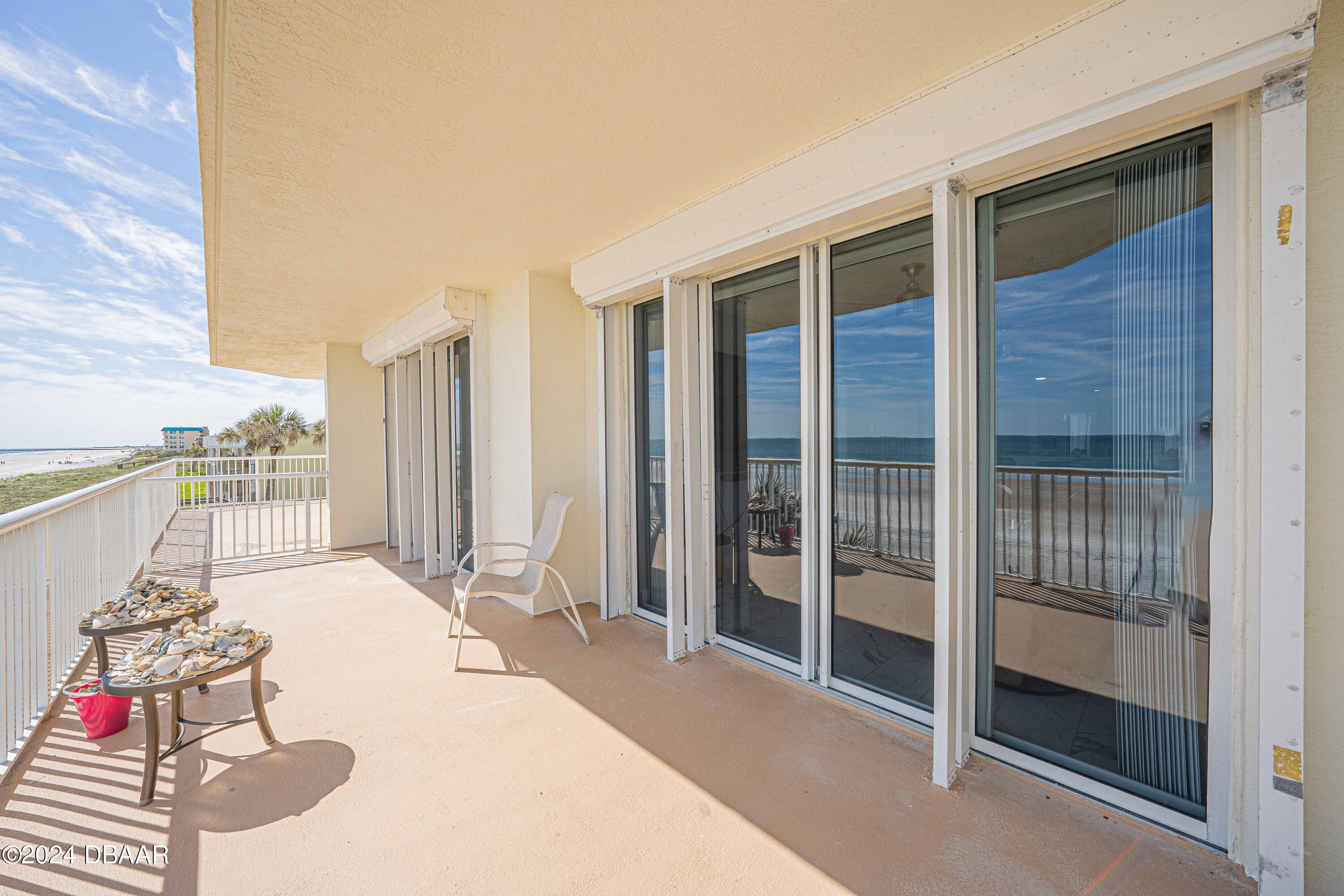 4767 South Atlantic Avenue, Unit 204 Ponce Inlet, FL 32127 - Photo 16 of 26 a very nice looking room with a large window and red walls