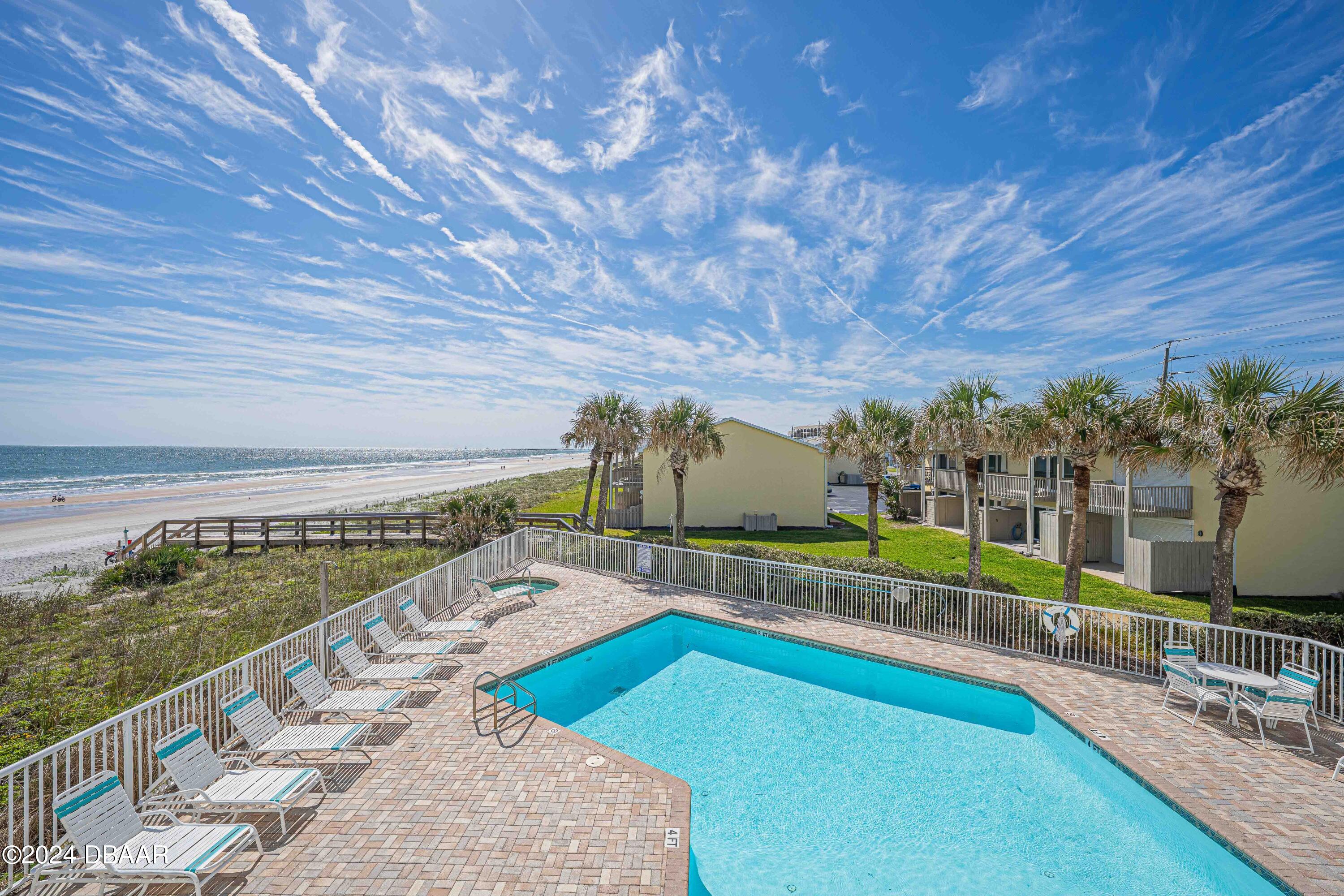 4767 South Atlantic Avenue, Unit 204 Ponce Inlet, FL 32127 - Photo 17 of 26 a view of a swimming pool with a patio