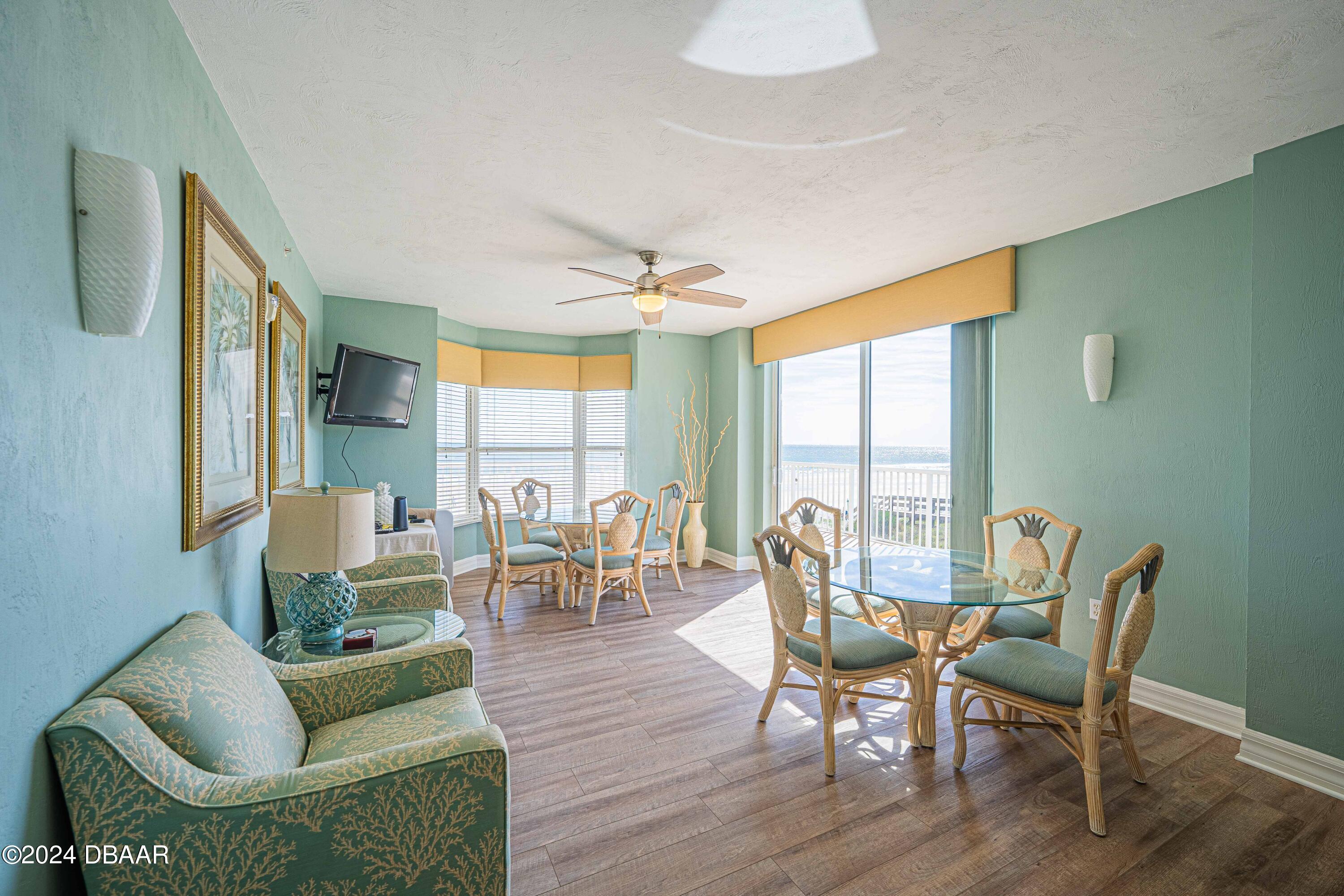 4767 South Atlantic Avenue, Unit 204 Ponce Inlet, FL 32127 - Photo 20 of 26 a living room with furniture and a large window
