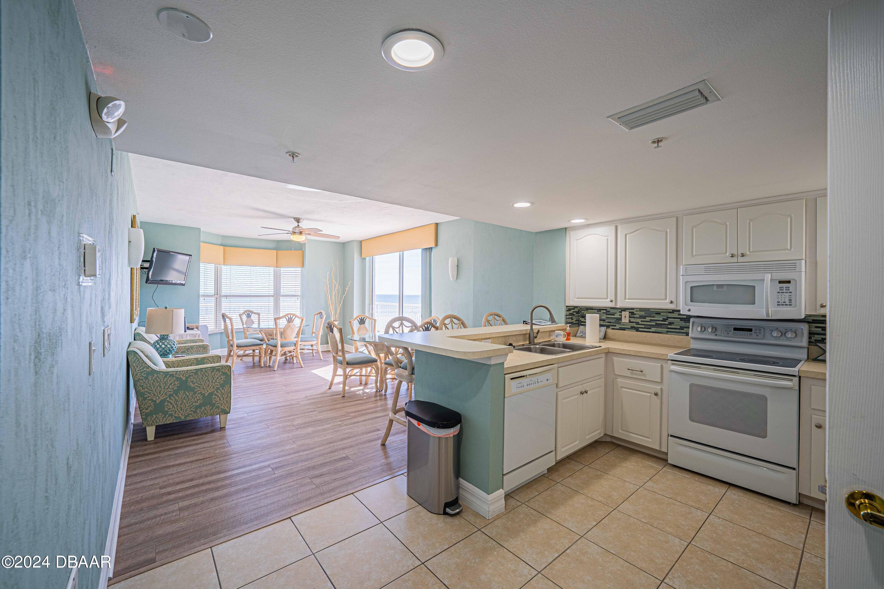 4767 South Atlantic Avenue, Unit 204 Ponce Inlet, FL 32127 - Photo 21 of 26 a kitchen with a sink appliances and cabinets