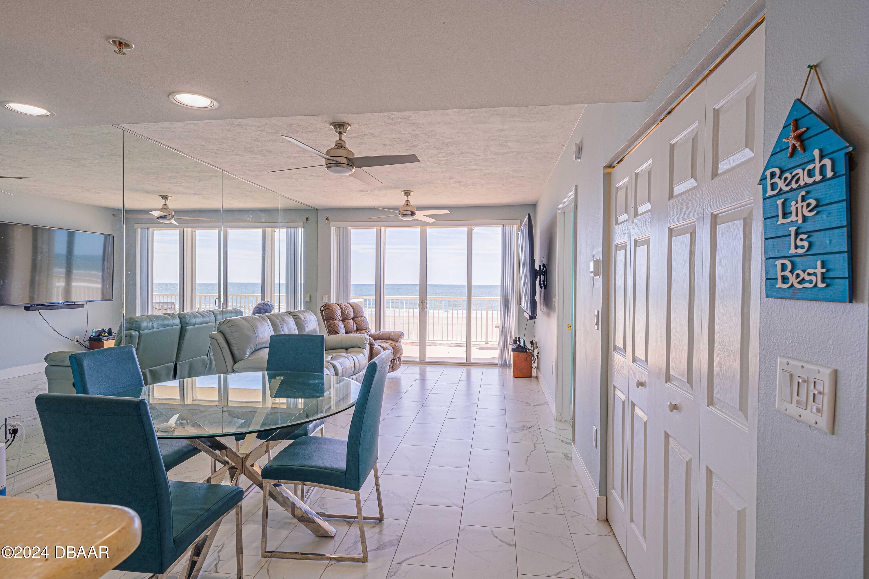 4767 South Atlantic Avenue, Unit 204 Ponce Inlet, FL 32127 - Photo 8 of 26 a view of a dining room with furniture and wooden floor