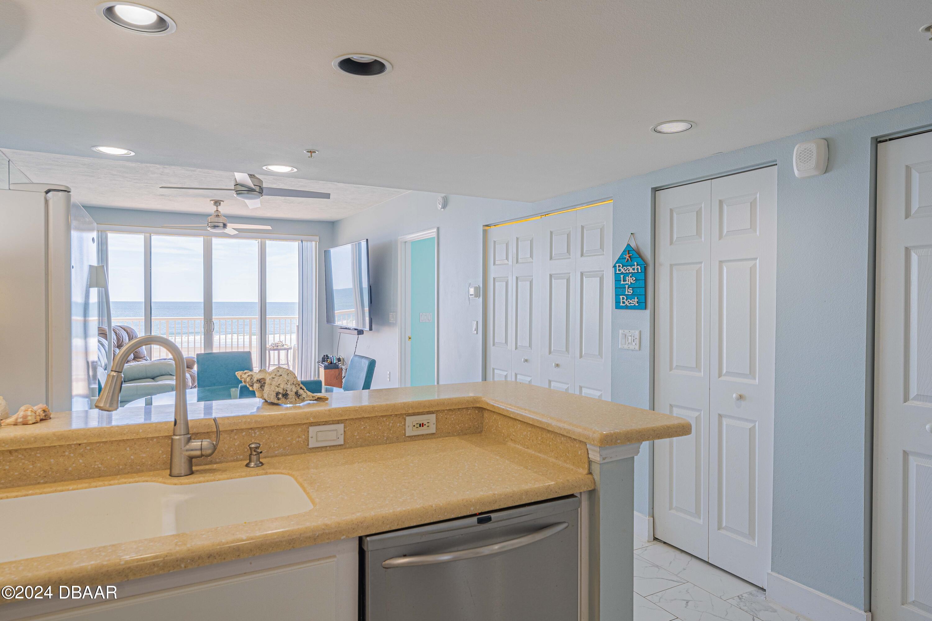 4767 South Atlantic Avenue, Unit 204 Ponce Inlet, FL 32127 - Photo 9 of 26 a bathroom with a granite countertop sink and a large mirror