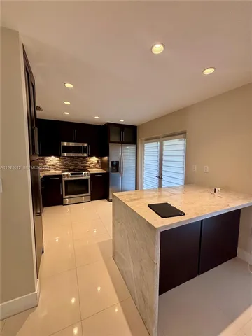 a kitchen that has a sink and a stove in it