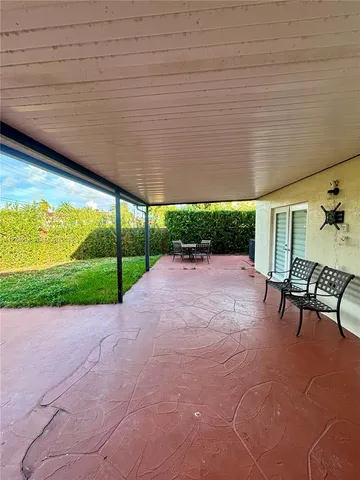 a view of a backyard with sitting area