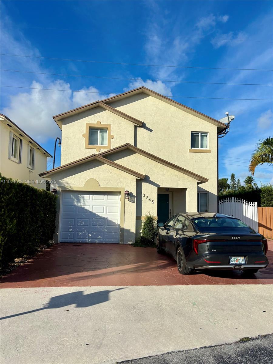 13765 Southwest 160th Terrace Miami, FL 33177 - Photo 2 of 47 a front view of a house with a yard