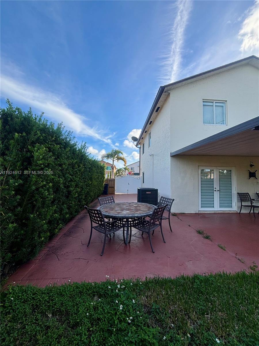13765 Southwest 160th Terrace Miami, FL 33177 - Photo 21 of 47 a backyard of a house with table and chairs