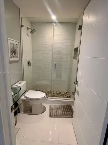 a bathroom with a toilet and shower