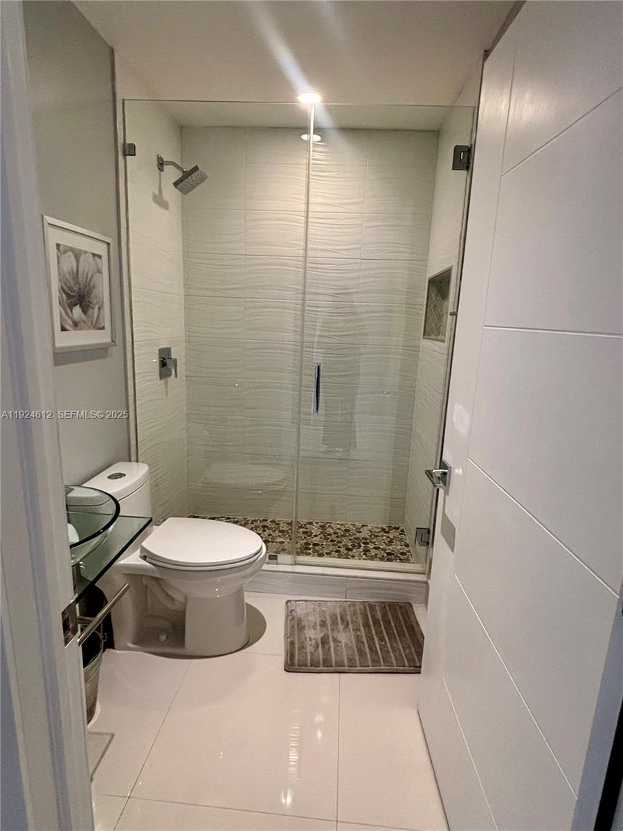 13765 Southwest 160th Terrace Miami, FL 33177 - Photo 22 of 47 a bathroom with a toilet and shower