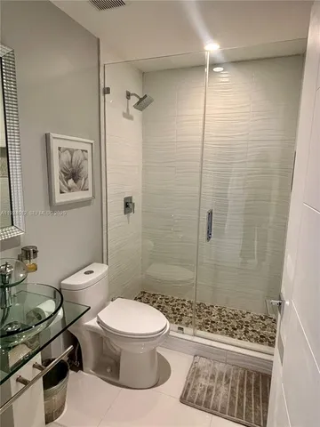 a bathroom with a toilet a sink and shower