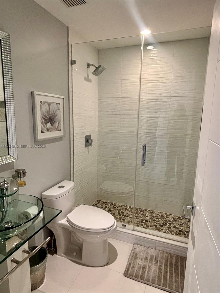13765 Southwest 160th Terrace Miami, FL 33177 - Photo 23 of 47 a bathroom with a toilet a sink and shower