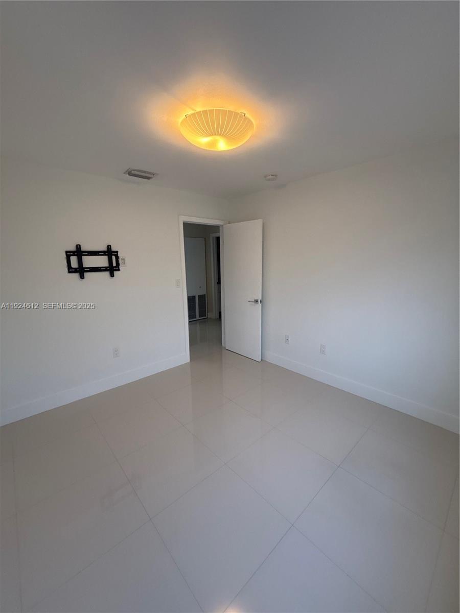 13765 Southwest 160th Terrace Miami, FL 33177 - Photo 26 of 47 a view of an empty room and a window