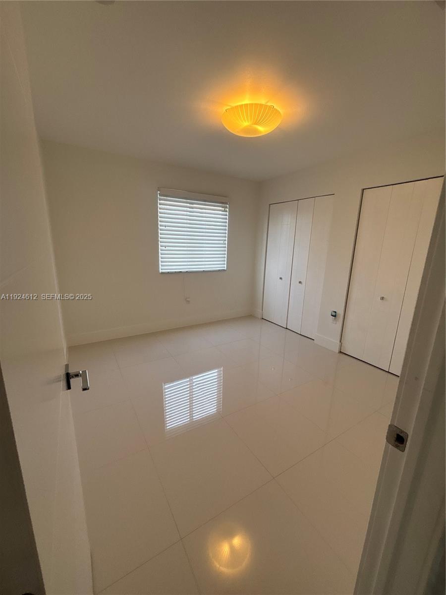 13765 Southwest 160th Terrace Miami, FL 33177 - Photo 33 of 47 a view of an empty room with a window