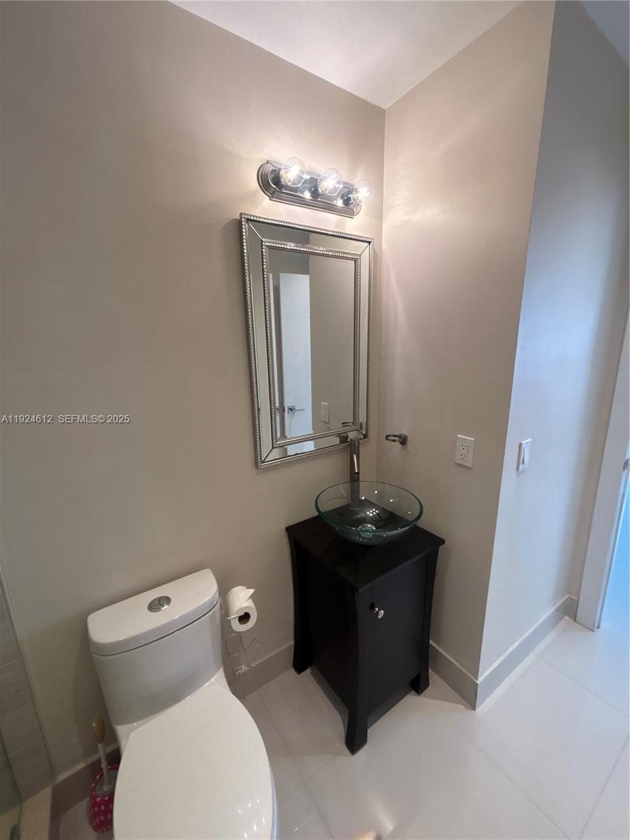 13765 Southwest 160th Terrace Miami, FL 33177 - Photo 37 of 47 a bathroom with a toilet sink and mirror