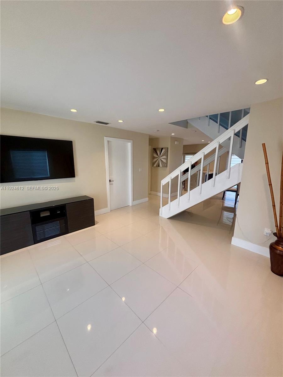 13765 Southwest 160th Terrace Miami, FL 33177 - Photo 4 of 47 a living room with furniture and a flat screen tv