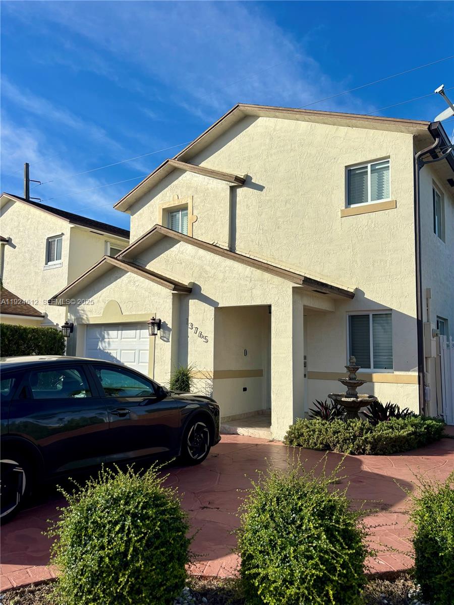 13765 Southwest 160th Terrace Miami, FL 33177 - Photo 42 of 47 a front view of a house with garden