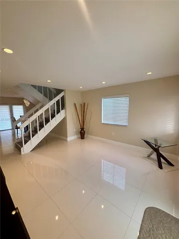 a view of an empty room with windows