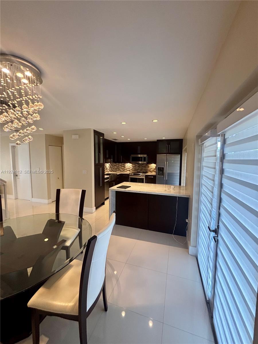 13765 Southwest 160th Terrace Miami, FL 33177 - Photo 8 of 47 a living room with furniture a fireplace and a table