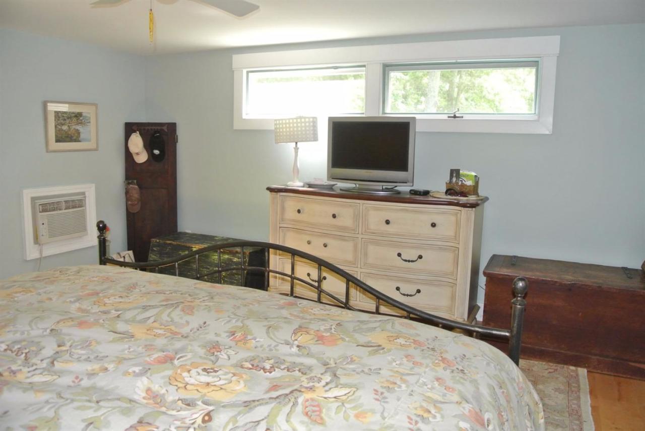83 Summersea Road Mashpee, MA 02649 - Photo 14 of 25 a bedroom with a bed and a flat screen tv