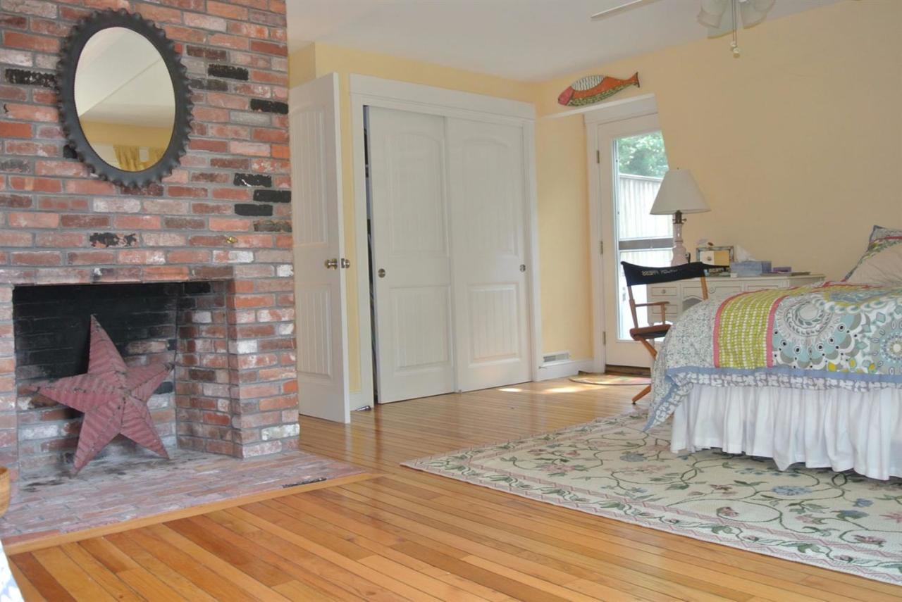 83 Summersea Road Mashpee, MA 02649 - Photo 8 of 25 a view of a livingroom with wooden floor and a fireplace